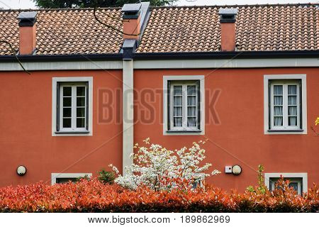 Red facade of building along the bicycle path of the Lambro valley (Monza Brianza Lombardy Italy) at spring