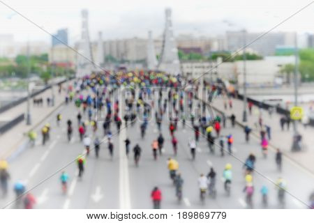 Abstract blurred background of mass urban cycling marathon. Cyclists go to the bridge, back to us. Concept of Sport, healthy lifestyle, aktivity.