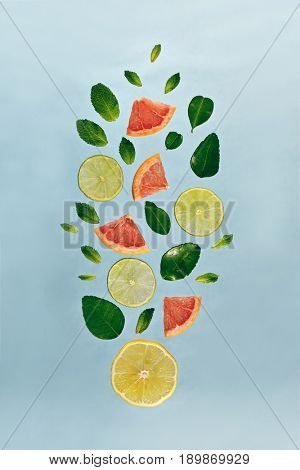 Summer Food and Drink - Fruit Lemonade Ingredient Pattern made of Lemon, Lime, Fresh Mint and Grapefruit. Splash Shape with Flying Drink Ingredient. Summer Fruit Drink Ingredient Concept. Flat Lay