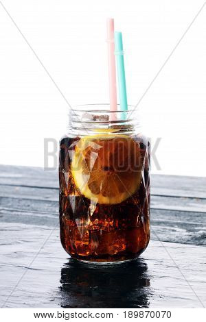 Softdrink With Ice Cubes, Lemon And Straw In Glass