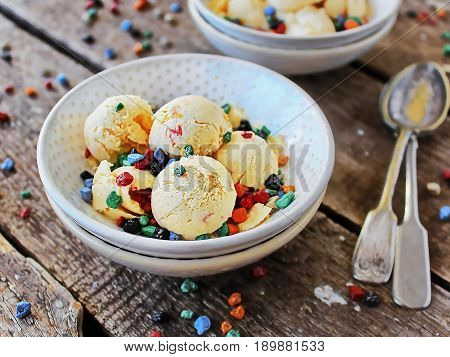 homemade ice cream peach light bowl with coloured chocolate - two bowls per frame, the spoon to the left