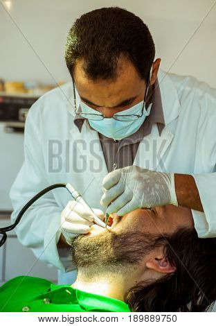 Man at the dentist clinic fixing his teeth
