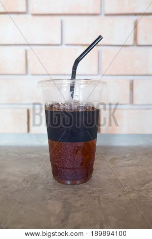 Plastic take away cup of iced black coffee americano