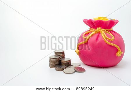 Piggy bank or money bag shaped money box with coins on white background in saving money concept copy space