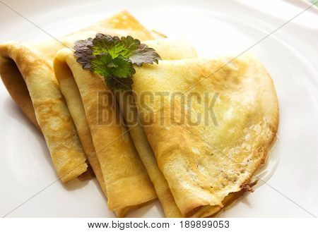 Maslenitsa traditional Russian pancakes - blini on a white plate of wood table