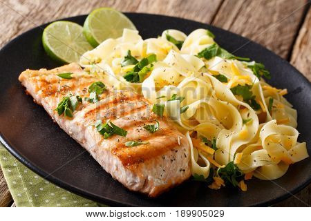 Grilled Salmon Fillet With Homemade Fetuccine Pasta Closeup. Horizontal