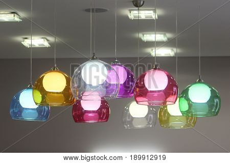 Lamps with colorful glass shades decorate the room. Vivid detail in the interior.