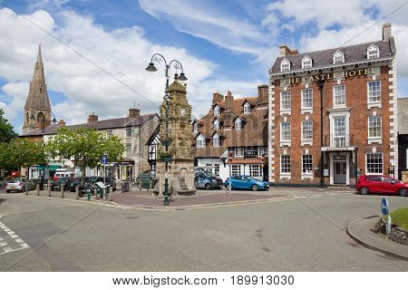 Ruthin Wales UK - June 4 2017: Saint Peters Square in Ruthin with it's historic buildings including the Castle Hotel Peers Memorial clock tower and Myddleton Arms nicknamed the Seven Eyes