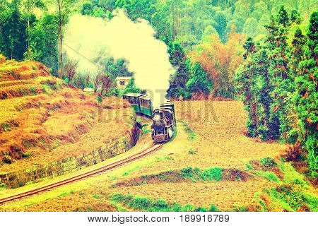 Steam narrow-gauge train moves from Yuejin to Bagou through the chinese countryside. Jiayang Mining Region. Sichuan province. China.