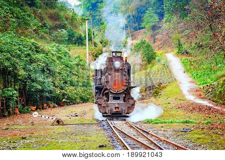 Steam narrow-gauge locomotive stands at the station on the way from Yuejin to Bagou. Mifenguan. Jiayang Mining Region. Sichuan province. China.