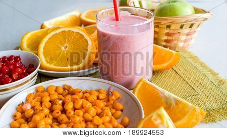 Juicy ripe oranges, sea buckthorn and viburnum table. Fruit Cocktail and Diet