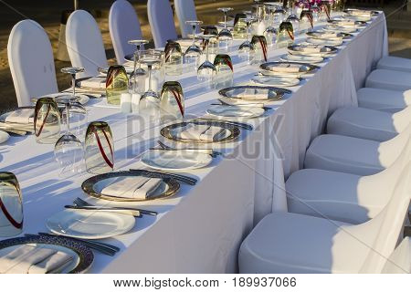 Table and chairs in empty beach restaurant during sunset. Island Koh Samui Thailand