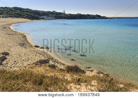 Summer seascape,Apulia coast: Marina di Pulsano beach (Taranto). The coastline is characterized by a alternation of sandy coves and jagged cliffs overlooking a truly clear and crystalline sea.