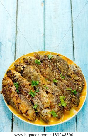 Fried fish with golden crisp skin on plate