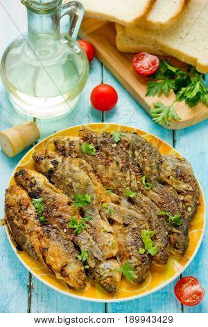 Fried fish with golden crisp skin on plate