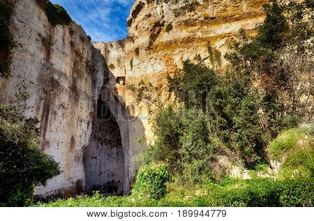 The entrance to the cavern known as the Orecchio di Dionisio (Ear of Dionysius) in the Archaeological Park in Syracuse, Sicily, Italy