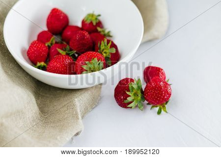 Fresh raw healthy diet strawberries fruit in plateisolated on whiteview aboveflatlay close-upcopyspace for textframe.Village rustic canvascountryside food