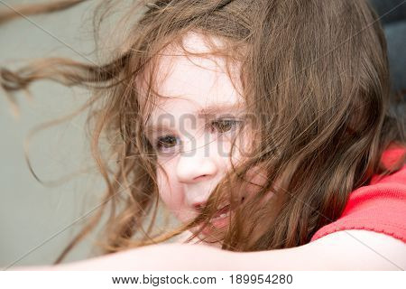 Happy Young Girl on Amusement Ride with Hair Blowing in the Wind