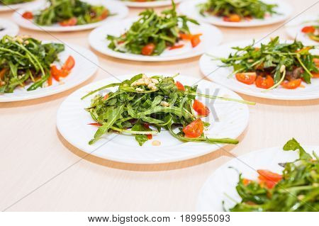 Fresh salad with chicken, tomatoes and mixed greens arugula, mesclun, mache on the table. Healthy food