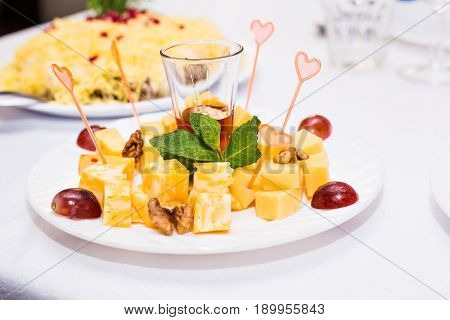 Cubes of yellow cheese on the plate