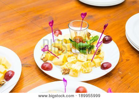 Cubes of yellow cheese on the plate