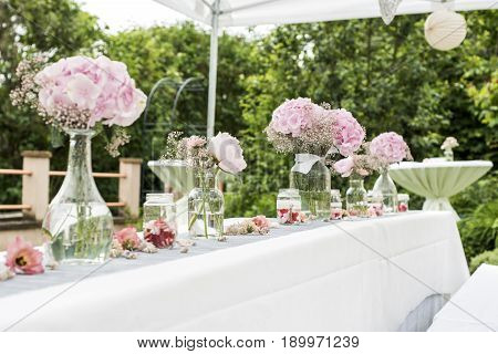 flowers settings decoration outdoor setup for a wedding with pink colored flower