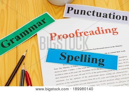 proofreading paper on table with office supplies