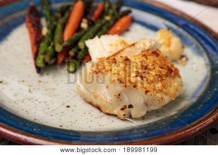White Flakey Sea Bass With Breadcrumbs And Roasted Asparagus And Carrots