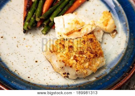 White Flakey Sea Bass With Breadcrumbs And Roasted Asparagus And Carrots