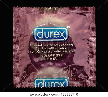 New York May 26 2017: Single Durex condom isolated against black background.