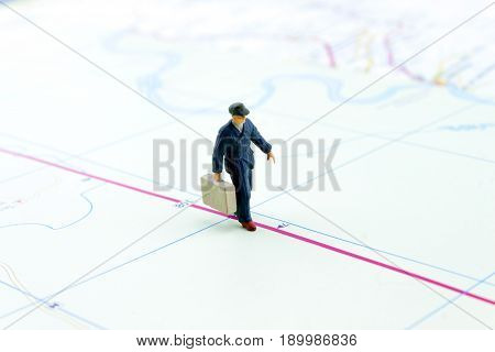 miniature businessman people walking on the map travel concept