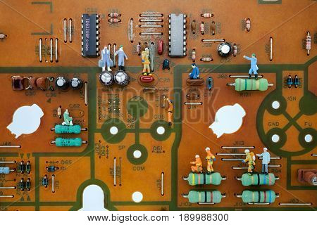 miniature technician peoples are working on circuit board