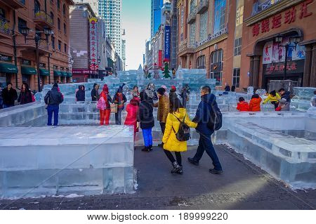 Harbin, China - February 9, 2017: Unknown tourists visiting the ice sculptures in Zhongyang pedestrian street, central street is a commercial long corridor of European architectural art