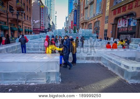 Harbin, China - February 9, 2017: Unknown tourists visiting the ice sculptures in Zhongyang pedestrian street, central street is a commercial long corridor of European architectural art