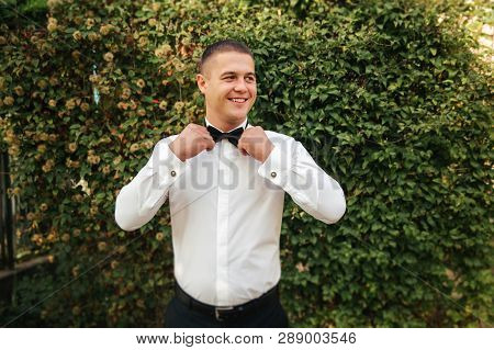 Handsome Groomm Dressed A Tie Bow. Wedding Day. Man Outside