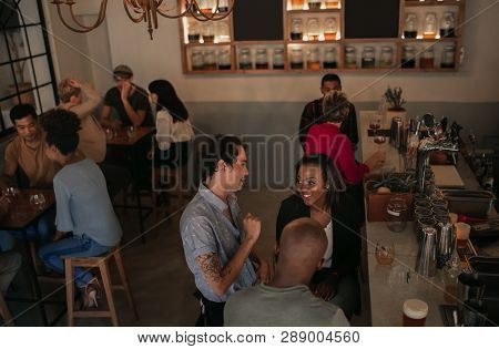 Young People Enoying Themselves In A Bar At Night