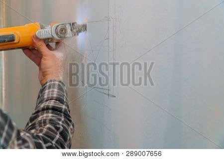 Construction Worker Cutting Gypsum Drywall By Using Electric Cutter Angle Grinder