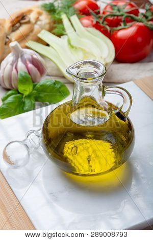 Virgin Natural Olive Oil Is Glass Bottle, Served With Traditional Mediterranean Food, Fresh Tomatoes