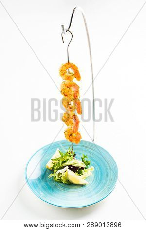 Grilled shrimp skewers. Seafood, shelfish. Shrimps Prawns skewers with herbs, garlic and lemon 