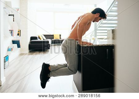 Man Training Chest Doing Low Chest Push-ups On Kitchen Counter