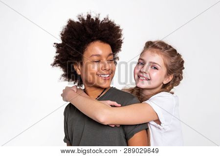 Pleasant Dark-haired Boy With Wild Hairstyle Looking On His Girlfriend