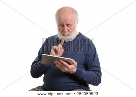 Funny bald and bearded old man using tablet computer, isolated on white