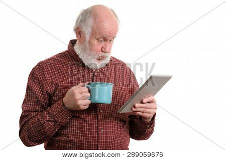 Funny shocked senior man with blue mug using tablet computer, isolated on white