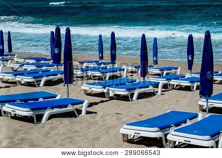 Empty Beach Umbrellas And Chairs On An Empty Sandy Coast Early In Spring At Limassol Cyprus