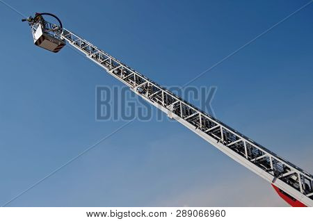 Fire Truck Lift In The Blue Sky. Putting Out Fires And Saving People. Mechanisms And Devices