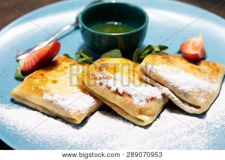 Pancakes With Sweet Berry Sauce And Fresh Berries
