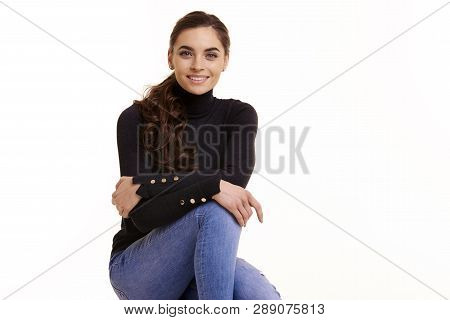 Cheerful Young Woman Sitting At Isolated White Background