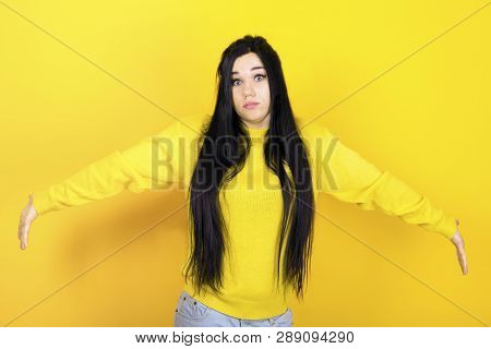 Surprised Terrified Female Gestures With Uncertainty, Stares At Camera, Puzzled As Doesn`t Know Anws