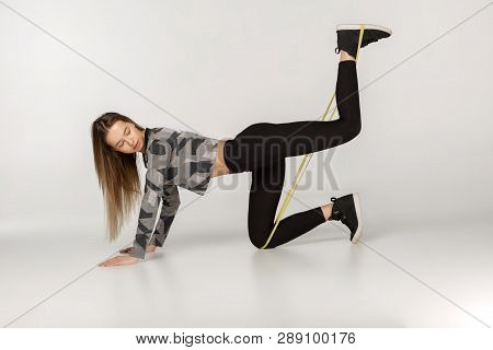 Young Sporty Woman Doing Exercises With Rubber Band