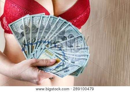 Young Woman Dressed In Burgundy Lingerie Count A Money, New One Handred Dollars Banknotes.